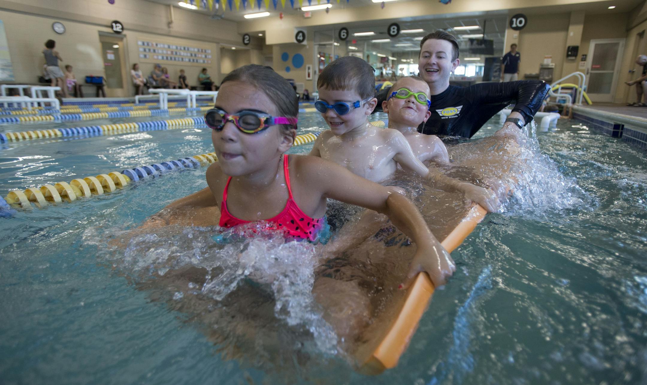 Foss swim instructor, Ross Mckenzie, plays "Magic Carpet" with his students. This is one of the most coveted games among all swim students at Foss and involves shaking the kids on a floating foam mat. ] ALEX KORMANN • alex.kormann@startribune.com Foss Swimming School has gained a huge following in the Twin Cities and surrounding areas. There are seven (soon to be eight) locations throughout Minnesota. At the Chanhassen location, swim instructors bring a seemingly never ending level of ene