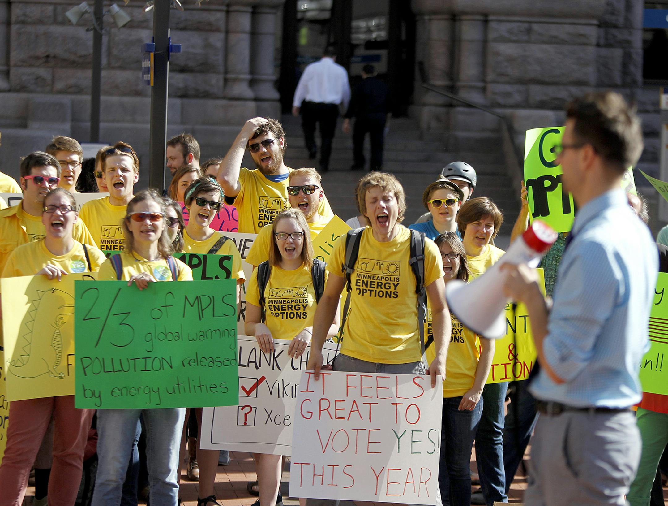 Outside City Hall, environmental activists expressed opinions on global warming and their support for putting the question on the November ballot on whether the city should form its own utility.