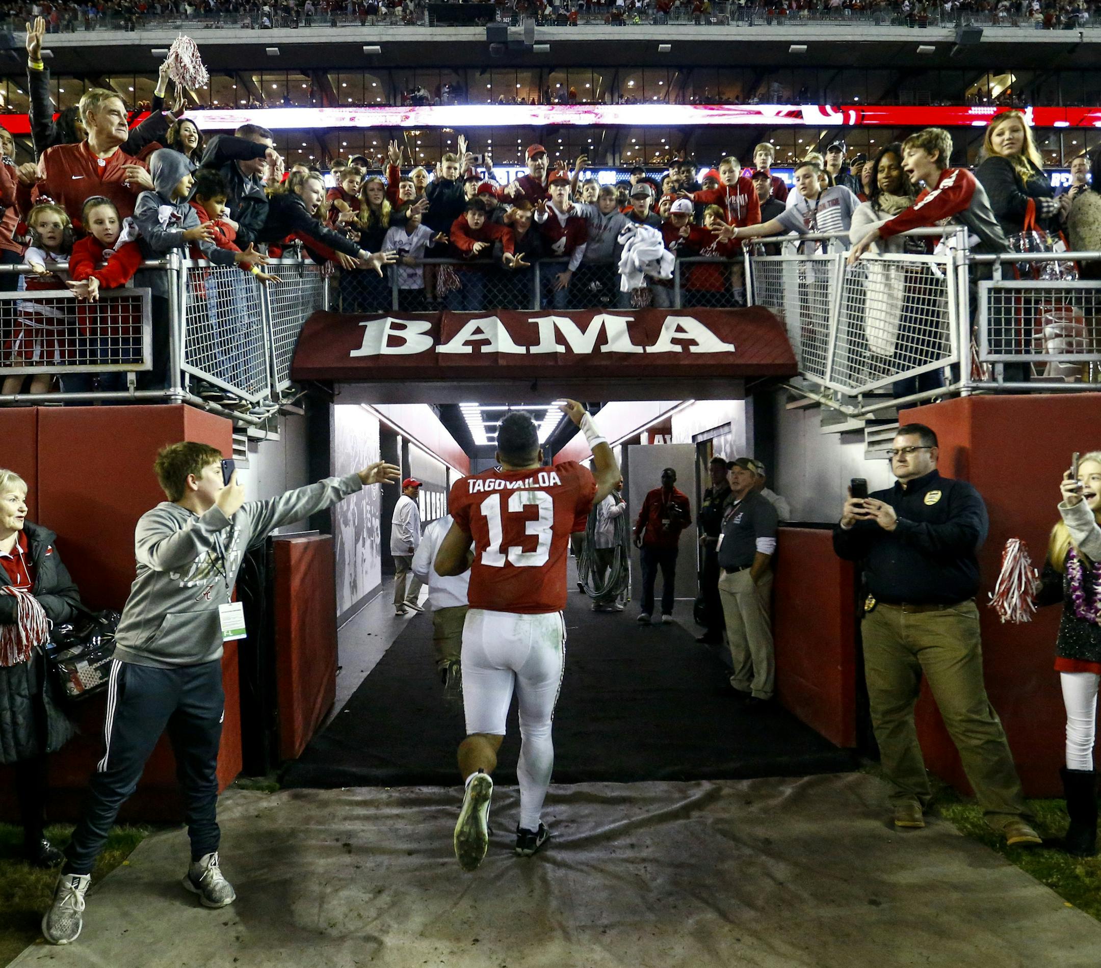 Alabama quarterback Tua Tagovailoa (13) waves to fans as he runs off the field after an NCAA college football game against Auburn, Saturday, Nov. 24, 2018, in Tuscaloosa, Ala. (AP Photo/Butch Dill)