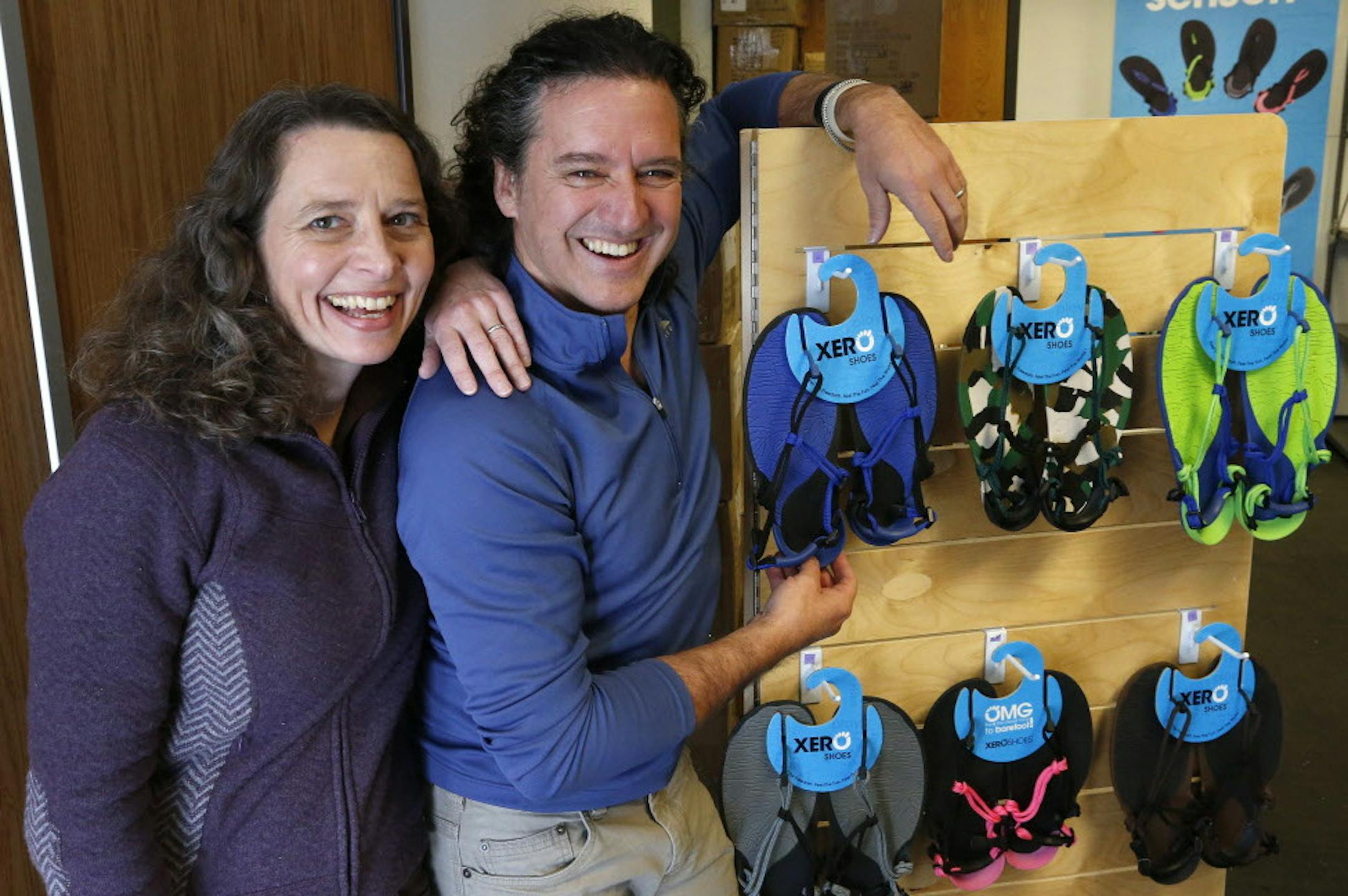 In this Dec. 30, 2014 photo, husband and wife team and cofounders of Xero Shoes, Lena Phoenix and Steven Sashen, stand with a display of a few examples of their company's sandals, as they move into their newer, larger headquarters, in Broomfield, Colo. The two hope for an easier time getting a Small Business Administration loan in the new year. The application and approval process they went through for a $500,000 loan in 2014 took eight months, longer than the two months their lender initially f