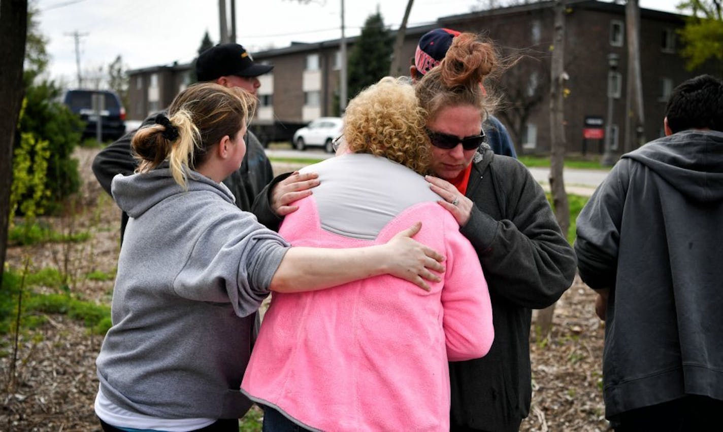 Family members of Ryan Reeves, 32, who died after his car hit a tree at the end of a police chase, gathered here at the place where he died near the corner of Hamline Ave N and Wynne Ave.St. Paul. Reeves mother Tracy Reeves is in the middle of the group.