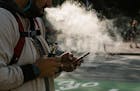 FILE -- A man uses a vaporizer in San Francisco, Calif., June 20, 2019. Gov. Gretchen Whitmer of Michigan said Wednesday, Sept. 4, that she would outl