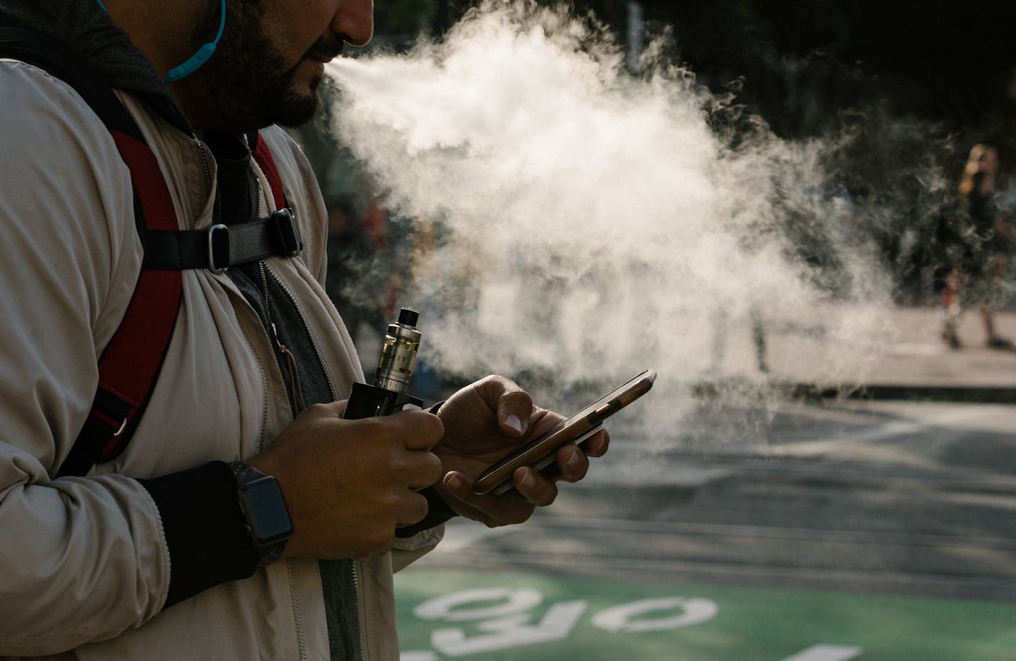 FILE -- A man uses a vaporizer in San Francisco, Calif., June 20, 2019. Gov. Gretchen Whitmer of Michigan said Wednesday, Sept. 4, that she would outlaw the sale of flavored e-cigarettes in her state, part of a national crackdown on vaping amid a recent spike in illnesses tied to the products. (Jason Henry/The New York Times)