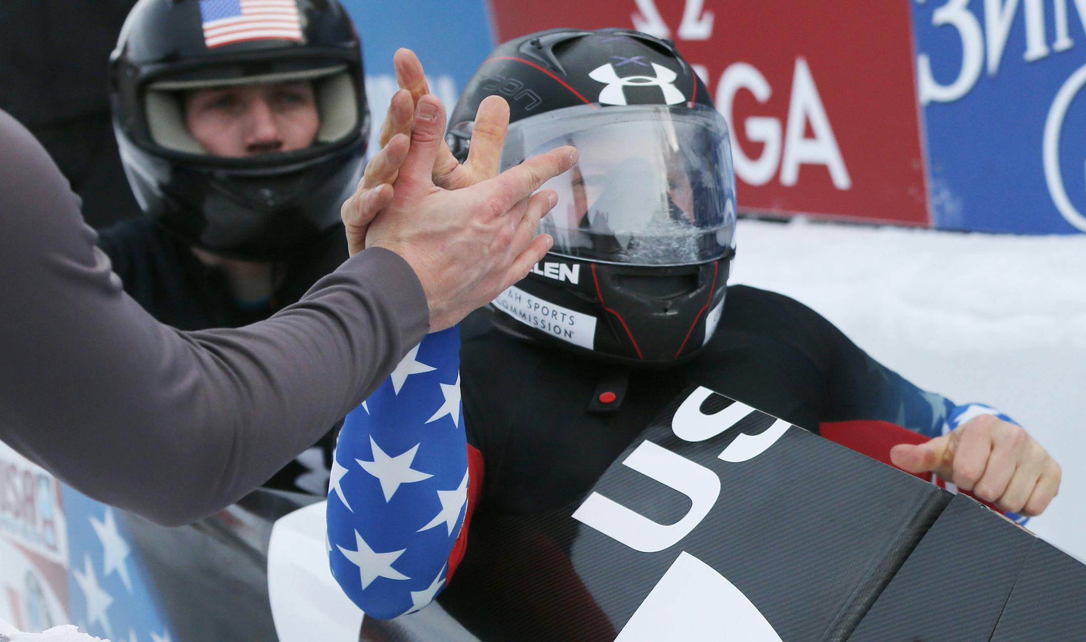 United States' pilot Steven Holcomb, right, and brakeman Christopher Fogt celebrate their win in the two-man bobsled World Cup event on Saturday, Dec. 14, 2013, in Lake Placid, N.Y. (AP Photo/Mike Groll)