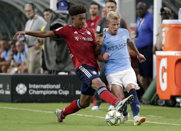 FC Bayern's Chris Richards, left, takes the ball from Manchester City midfielder Oleksandr Zinchenko in a July 2018 International Champions Cup tourna