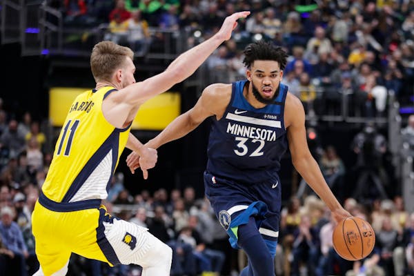 Timberwolves center Karl-Anthony Towns drives around Indiana Pacers forward Domantas Sabonis during a game in January.