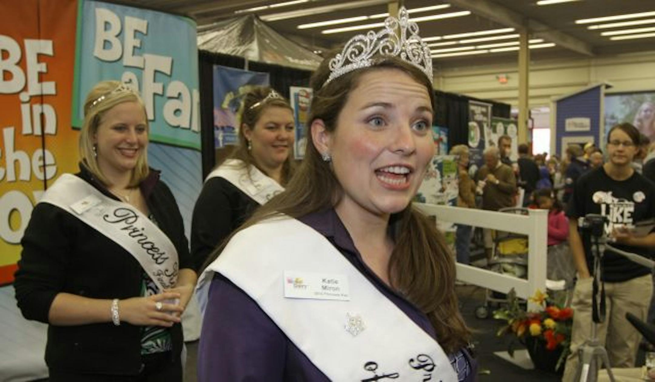 (left to right) Flanked by her court, Karen Anderson and Michaela Bengtson, 2010 Princess Kay of the Milky Way, Katie Miron talked with state fair goers at the Dairy Building.