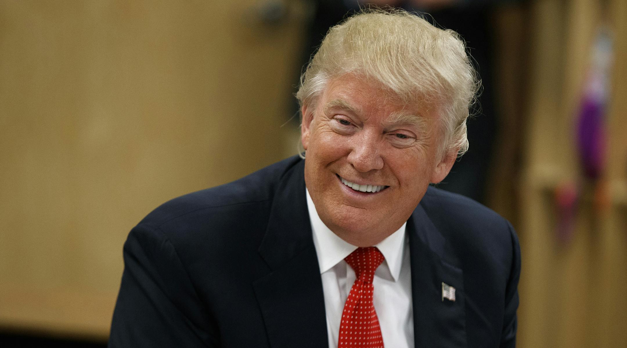 Republican presidential candidate Donald Trump smiles as he meets with students and educators before speaking about school choice, Thursday, Sept. 8, 2016, at Cleveland Arts and Social Sciences Academy in Cleveland. (AP Photo/Evan Vucci) ORG XMIT: MIN2016090914124014