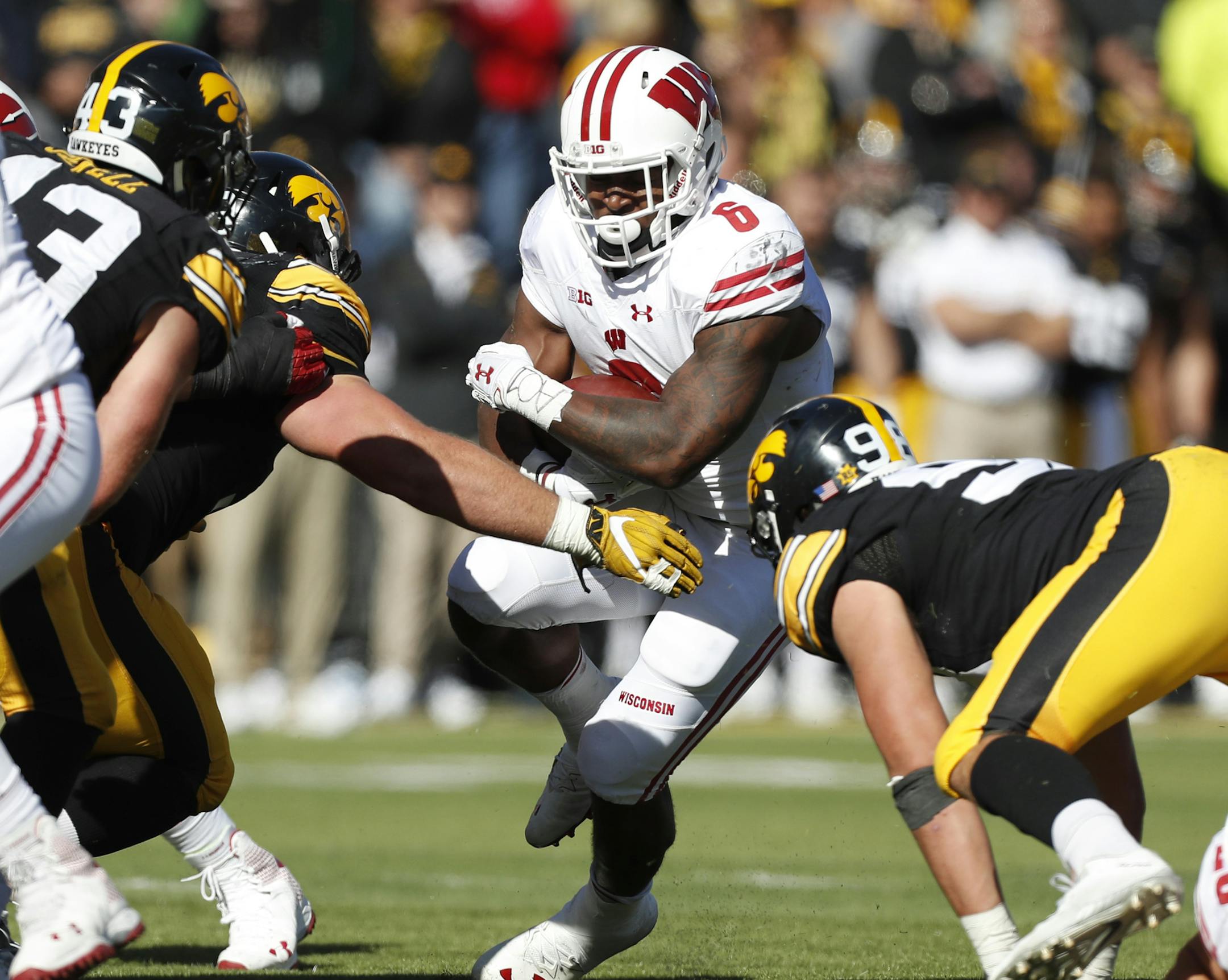 Wisconsin running back Corey Clement (6) runs from Iowa defenders during the first half of an NCAA college football game, Saturday, Oct. 22, 2016, in Iowa City, Iowa. (AP Photo/Charlie Neibergall)