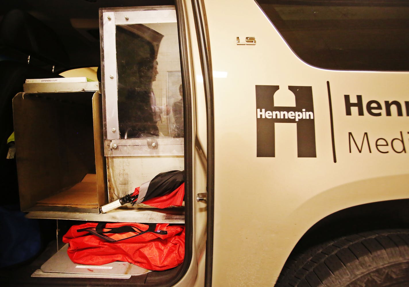 A Hennepin County Medical Examiner's office vehicle with a plexiglass space for holding a body in transport, seen at the Hennepin County Medical Examiner's office Thursday, June 28, 2015 in Minneapolis, MN.](DAVID JOLES/STARTRIBUNE)djoles@startribune.com Families visiting the medical examiner's office for the traumatizing experience of identifying a loved one must search for parking in the shadow of the new Vikings stadium. The location of Chief Medical Examiner Dr. Andrew Baker's office is less than ideal and limits plans for expansion. Baker, who already oversees autopsy services for Dakota, Hennepin and Scott counties, said his office could eventually handle investigative services for Ramsey and Washington counties, and possibly counties in the state's Arrowhead region. He has discussed moving to a 4-acre site near the airport to accommodate the growth.