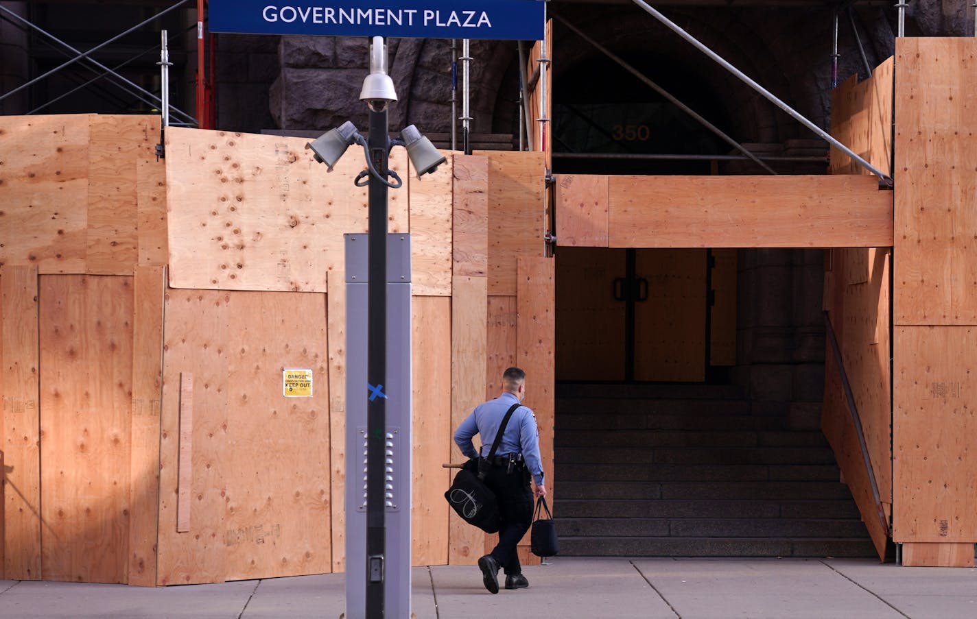 A Minneapolis police officer walked to City Hall with a bag of riot gear in early November.