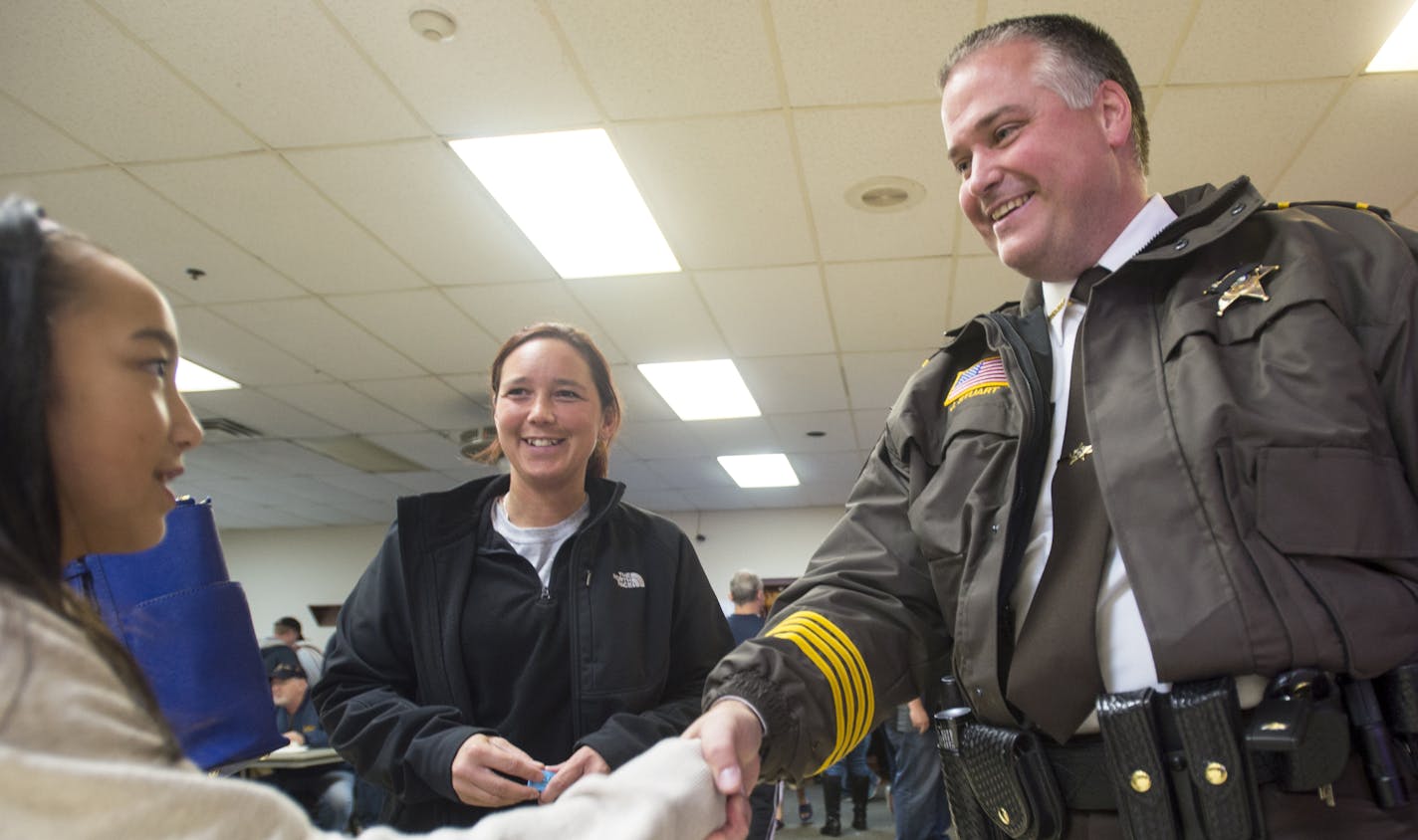 Ella Nguyen, 9, and her mother Jessie Warren, of Andover, were greeted by Anoka County Sheriff James Stuart at a pro-police rally Friday at the American Legion Post in Coon Rapids.