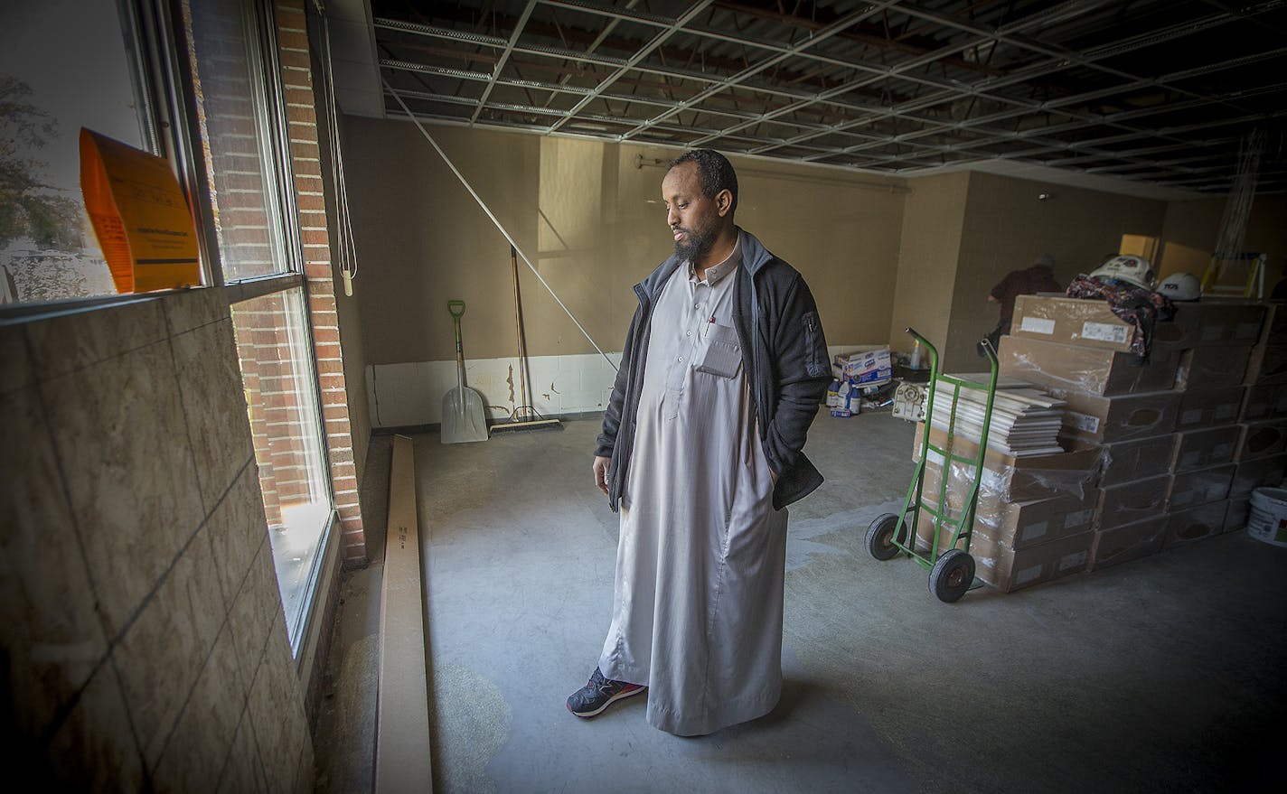 Mohamed Omar looked looked out the window that was once shattered from an explosive devise at the Dar Al Farooq Center, Friday, October 13, 2017 in Bloomington, MN. Dar Al Farooq is the mosque in Bloomington rocked by an explosive device almost exactly two months ago. The center is still working to rebuild not just the physical damage cause by what Gov. Dayton called an "act of terror," but the psychological damage incurred by many of its patrons. ] ELIZABETH FLORES &#xef; liz.flores@startribune