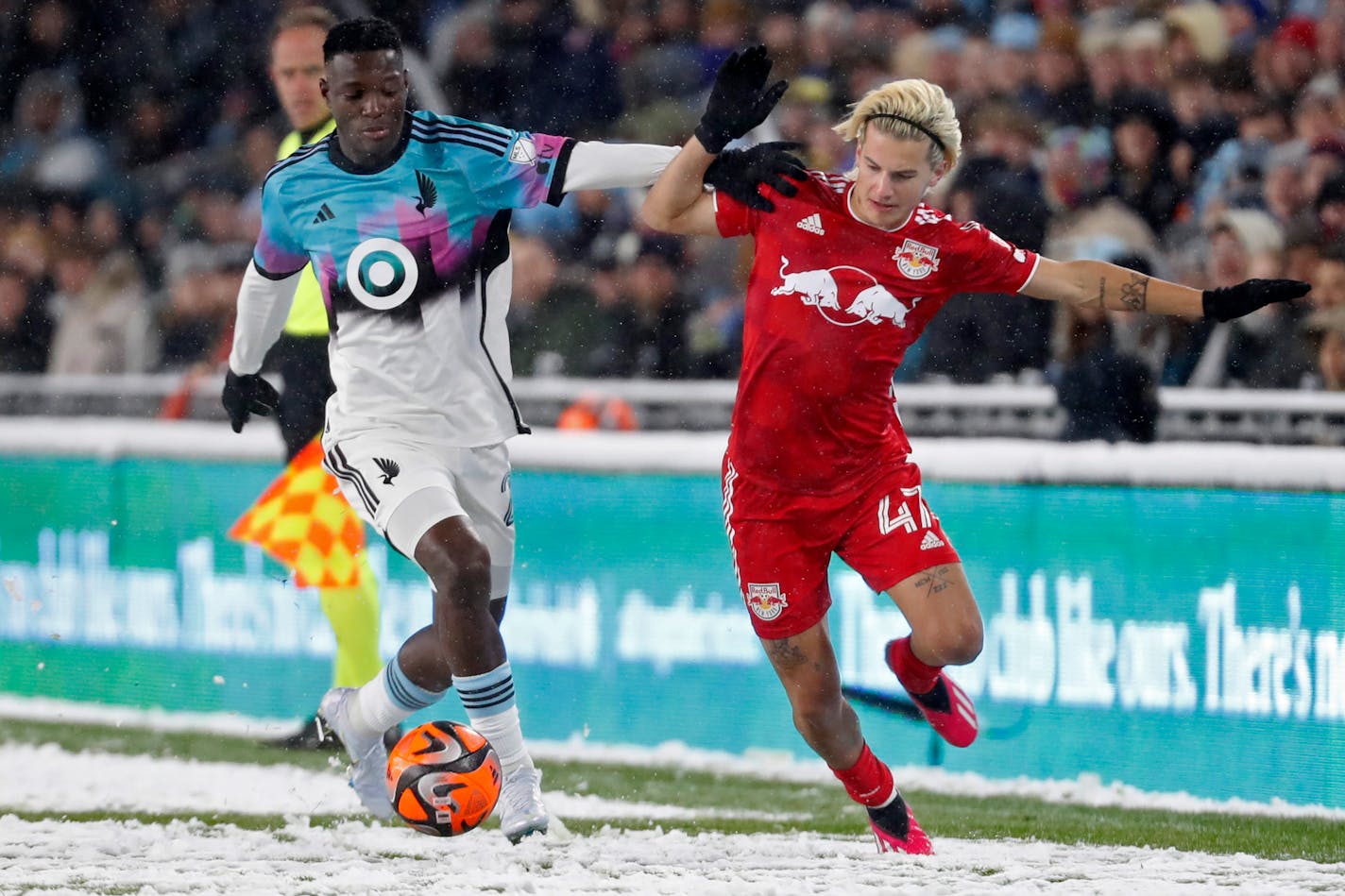 Minnesota United forward Bongokuhle Hlongwane, left, challenges New York Red Bulls defender John Tolkin, right, for the ball in the first half of an MLS soccer game Saturday, March 11, 2023, in Minneapolis. (AP Photo/Bruce Kluckhohn)