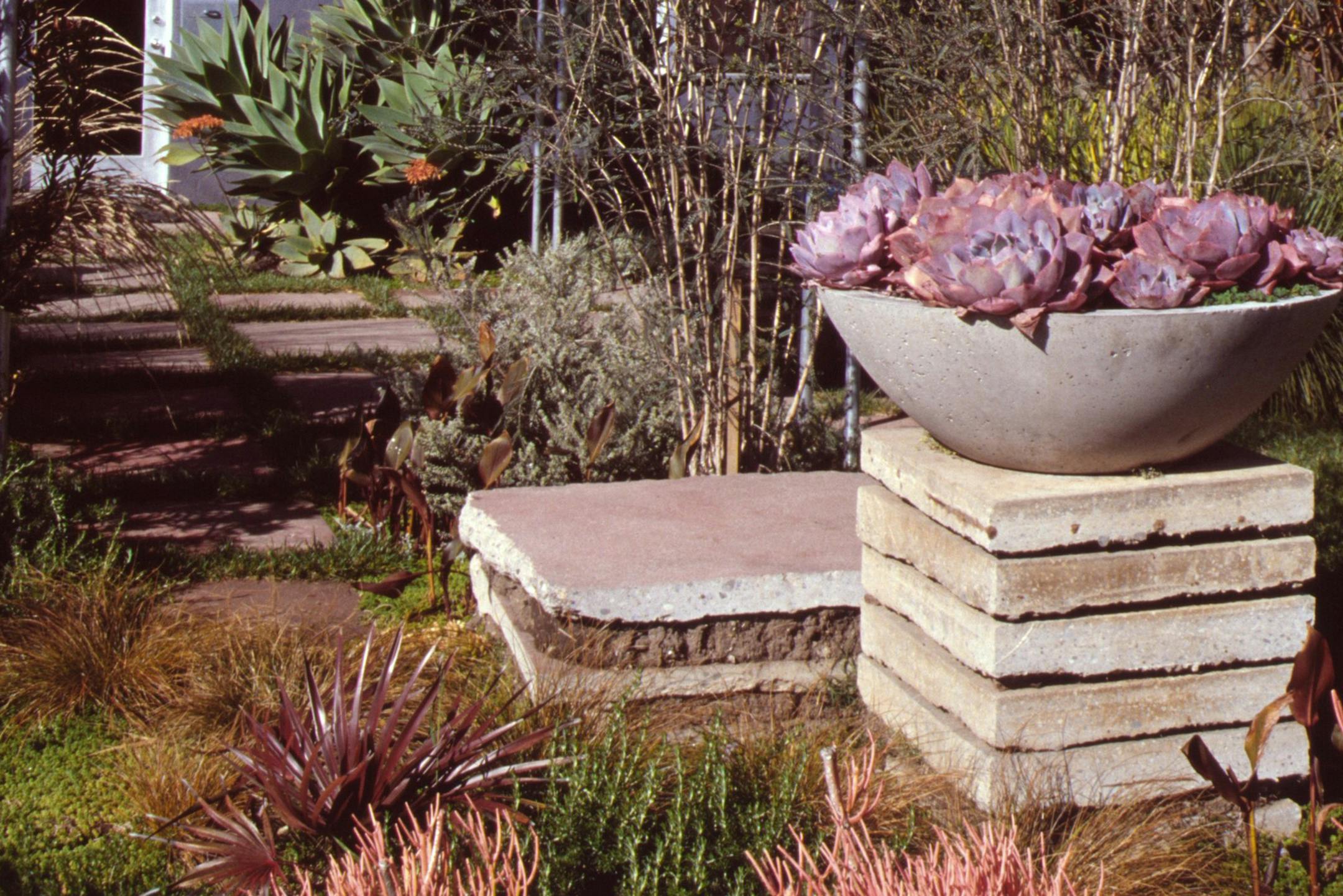 Precast concrete squares can be stacked to create a pedestal for pots and garden art. (Maureen Gilmer/MCT) ORG XMIT: 1147296