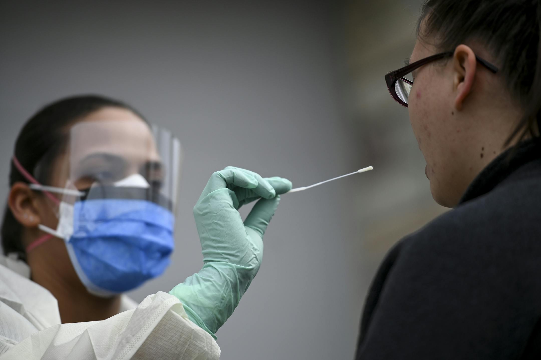 Reece Wallaker, a medical assistant with M Health Fairview, administered a COVID-19 test to an actor and fellow Fairview employee, Nichole Brown, outside the M Health Fairview Fridley clinic Tuesday.