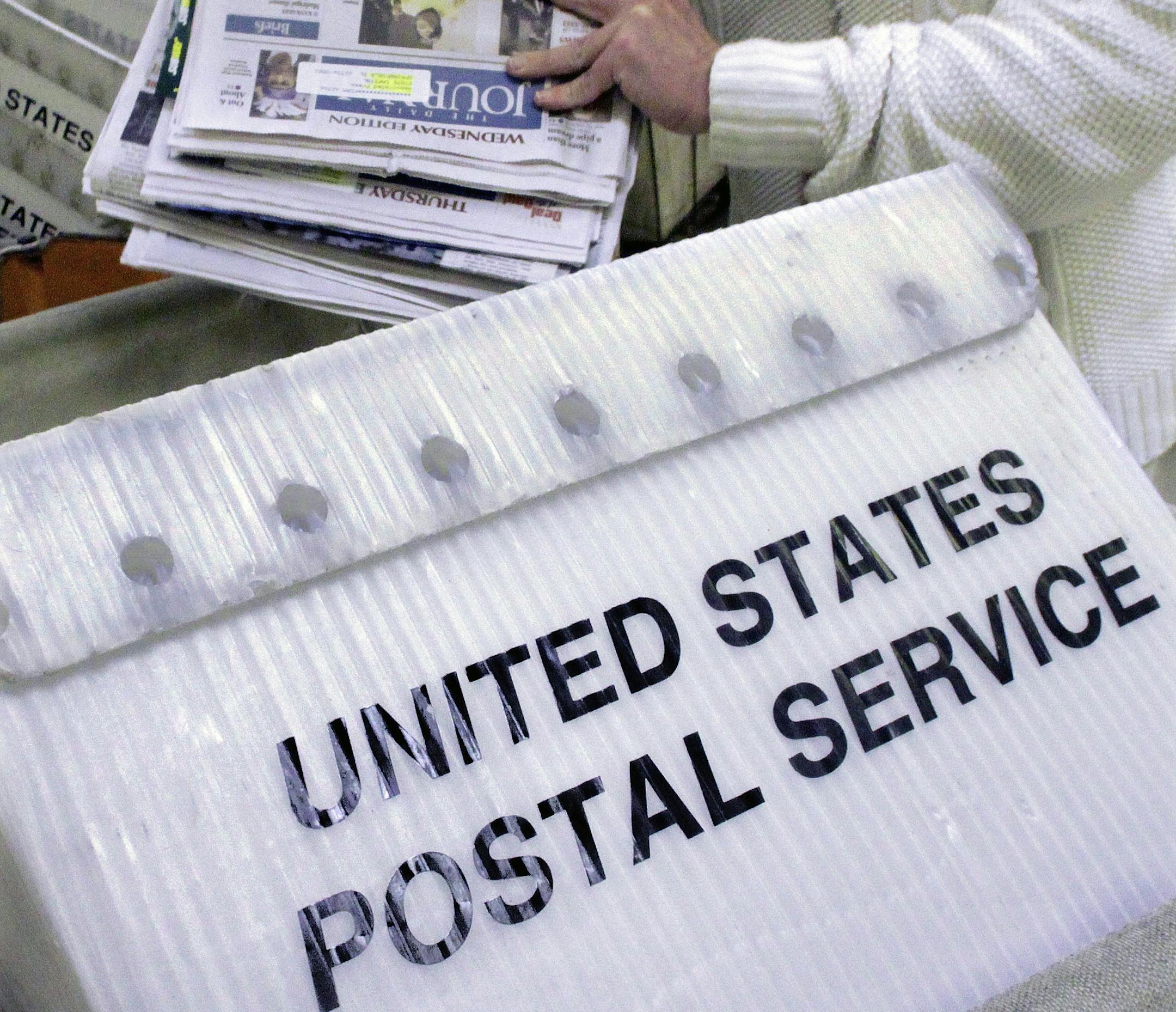 FILE - In this Dec. 5, 2011 file photo mail is loaded into bins for transport at the Capitol Station, in Springfield, Ill. The U.S. Postal Service is proposing to cut its rates for one of the nation's top direct marketing companies, a move that threatens the newspaper industry's biggest money-maker: the Sunday advertising bundle. (AP Photo/Seth Perlman, File) ORG XMIT: MIN2014111010213830