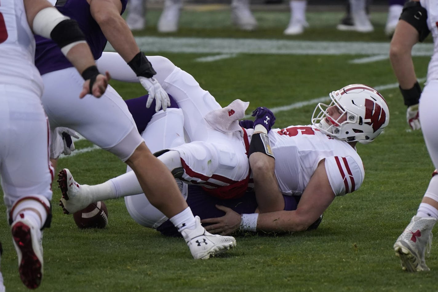 Wisconsin quarterback Graham Mertz is sacked by Northwestern linebacker Blake Gallagher during the first half of an NCAA college football game in Evanston, Ill., Saturday, Nov. 21, 2020. (AP Photo/Nam Y. Huh)