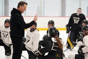 Newly named PWHL Minnesota head coach Ken Klee talked with his players during practice at the Tria Rink in St. Paul.