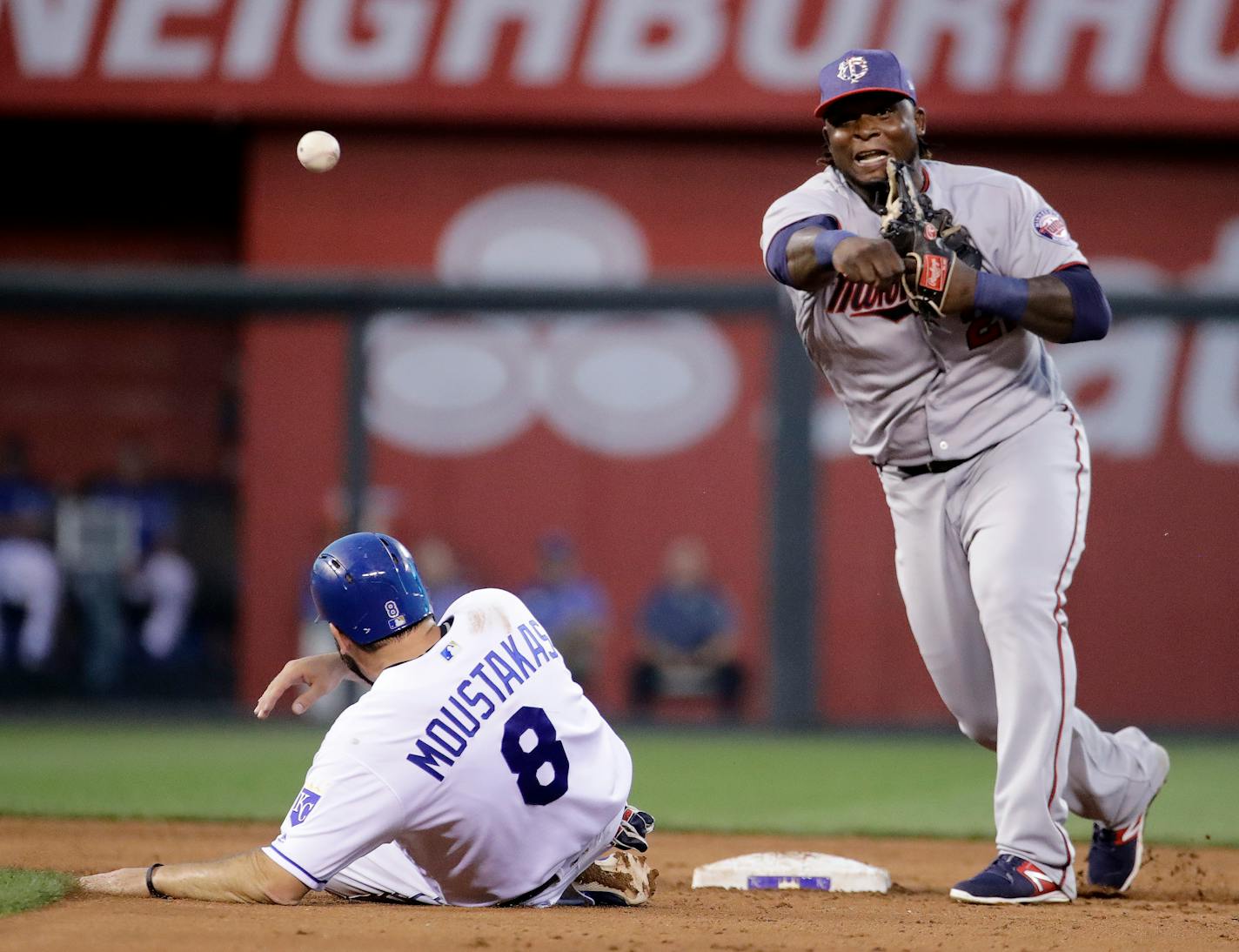 Minnesota Twins third baseman Miguel Sano, right, throws to first for the double play hit into by Kansas City Royals' Brandon Moss after forcing Mike Moustakas (8) out at second during the fourth inning of the second baseball game of a doubleheader Saturday, July 1, 2017, in Kansas City, Mo. (AP Photo/Charlie Riedel)