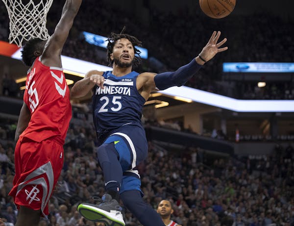 The Minnesota Timberwolves' Derrick Rose (25) passes the ball to a teammate in the second quarter against the Houston Rockets' Clint Capela (15) in Ga