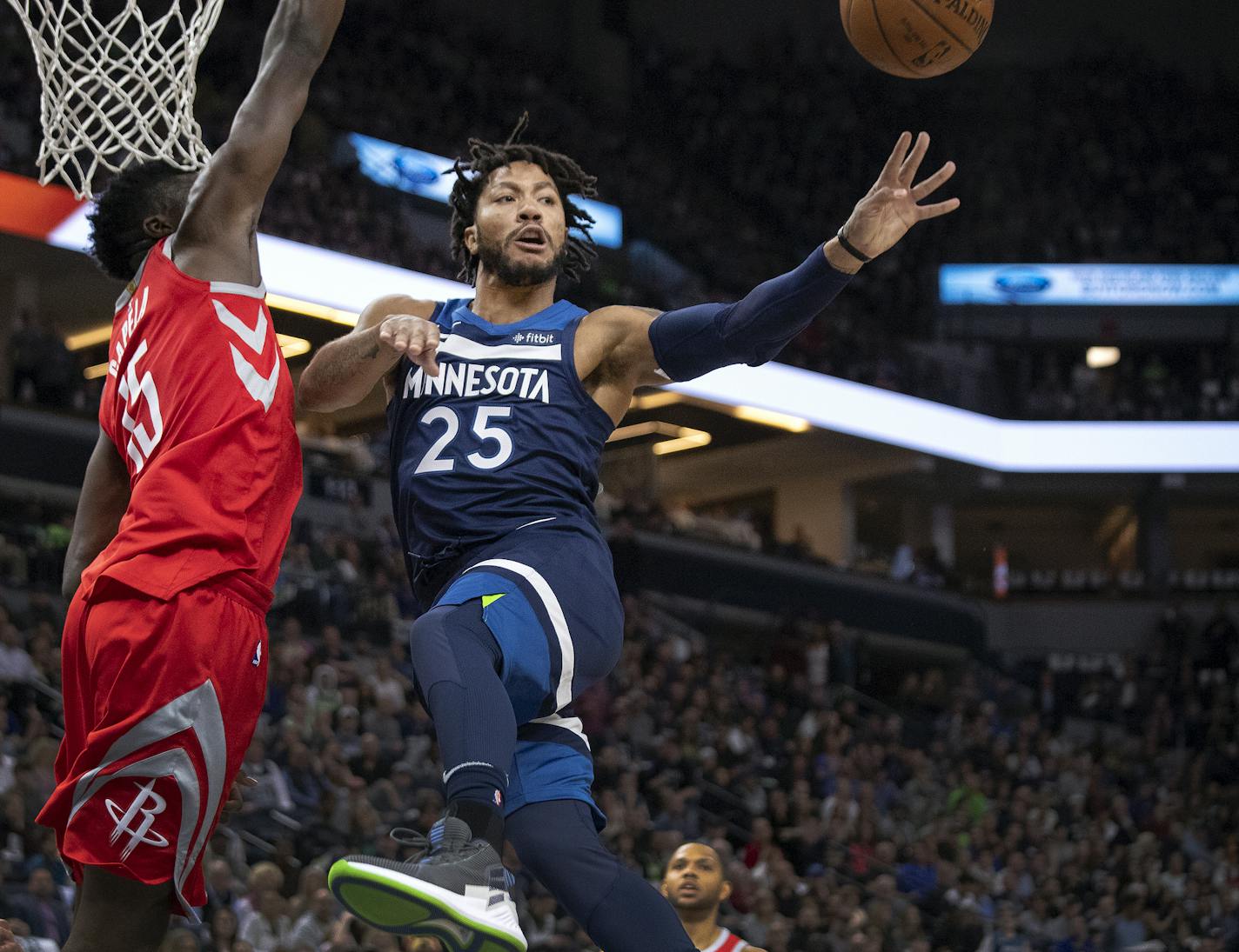 The Minnesota Timberwolves' Derrick Rose (25) passes the ball to a teammate in the second quarter against the Houston Rockets' Clint Capela (15) in Game 3 of the first-round NBA Playoff series on Saturday, April 21, 2018, at the Target Center in Minneapolis. (Carlos Gonzalez/Minneapolis Star Tribune/TNS) ORG XMIT: 1229228