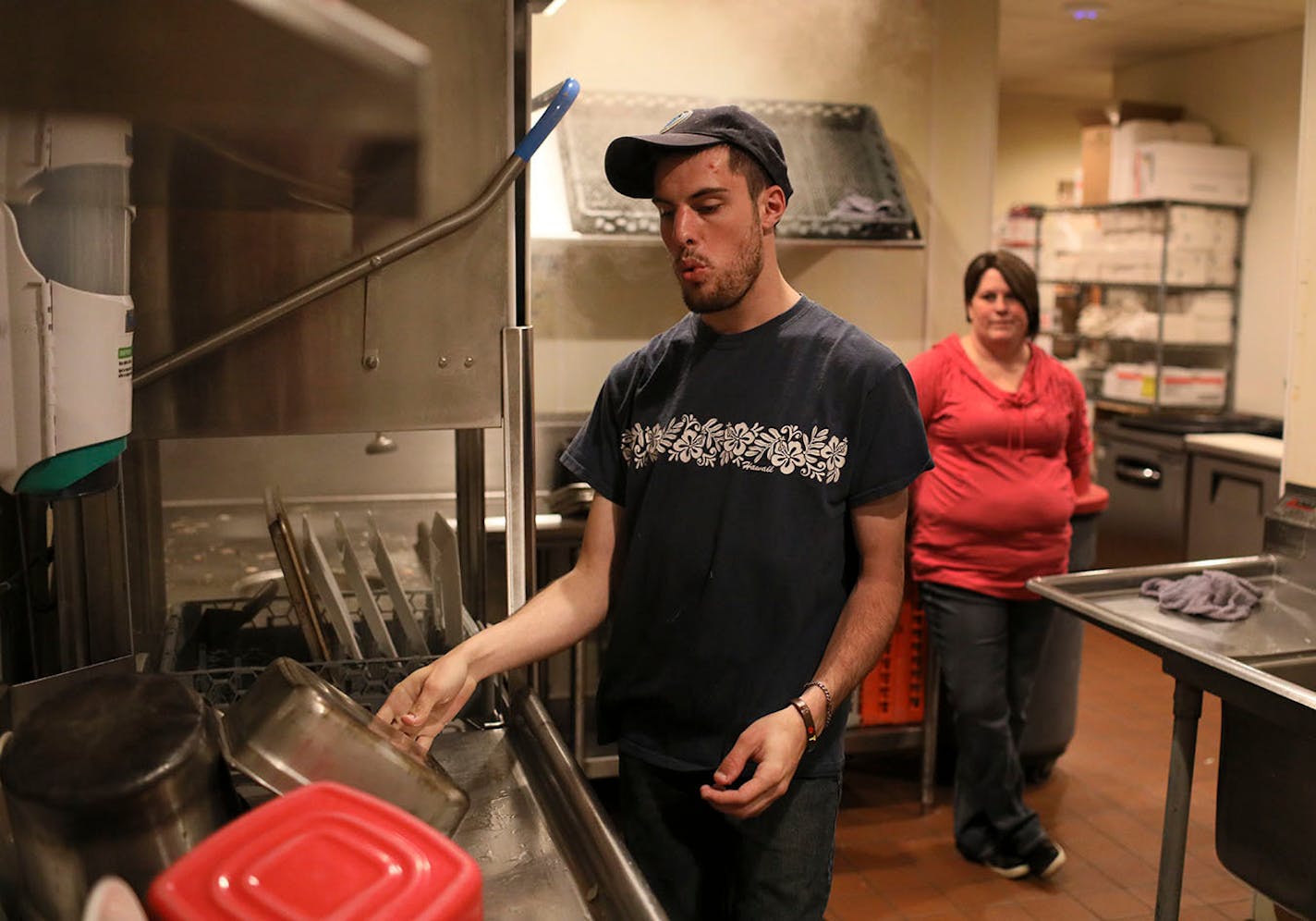 Like thousands of other high school graduates in Minnesota, Chris McIntire went straight to work at a segregated workshop, where he did menial factory work for sub minimum wages. Then in 2017, the state Vocational Rehabilitation program stepped in and found Chris a job for $10/hour at Friendly Buffalo Restaurant in Big Lake, Minn. Here, McIntire whistles to the Bob Dylan song The Times They Are a Changing', while washing dishes with his job coach Jaime Klatt looking on Friday, May 11, 2018, at t