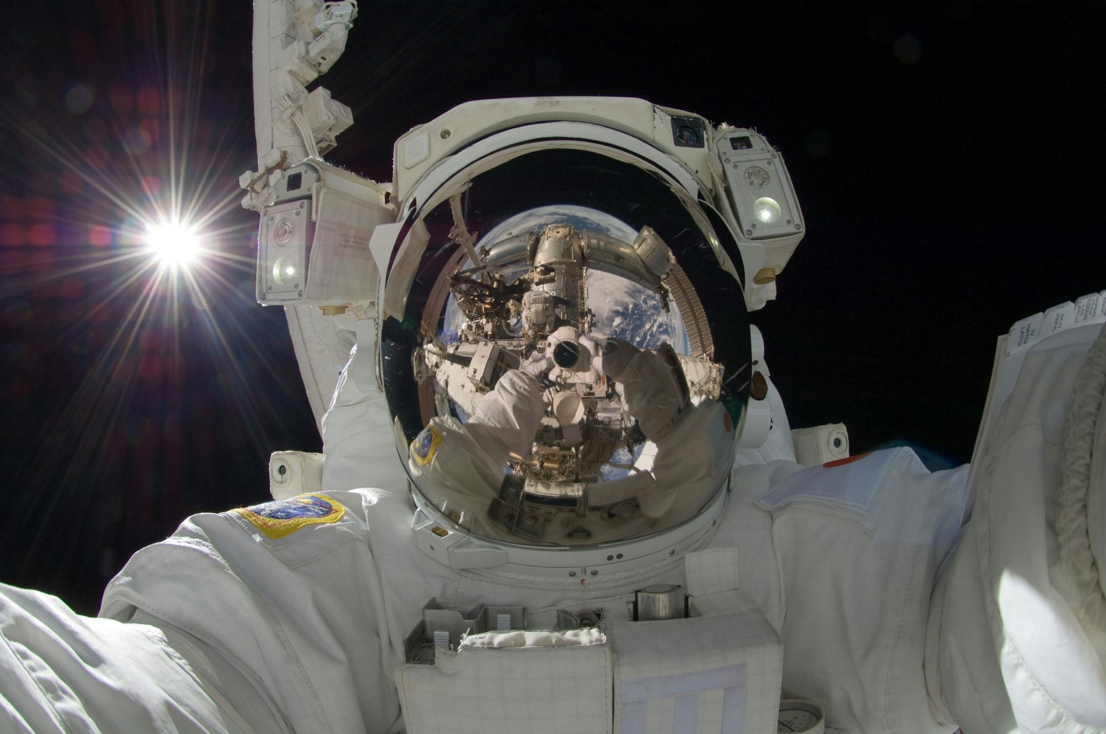 In this Sept. 5, 2012, file photo, provided by NASA, Japan Aerospace Exploration Agency astronaut Aki Hoshide used a digital still camera to expose a photo of his helmet visor during the mission's third session of extravehicular activity.