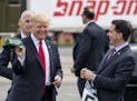 Gov. Scott Walker gives President Donald Trump a "Make The Bucks Great Again" hat and a jersey outside Snap-On Tools in Kenosha, Wis., April, 18, 2017