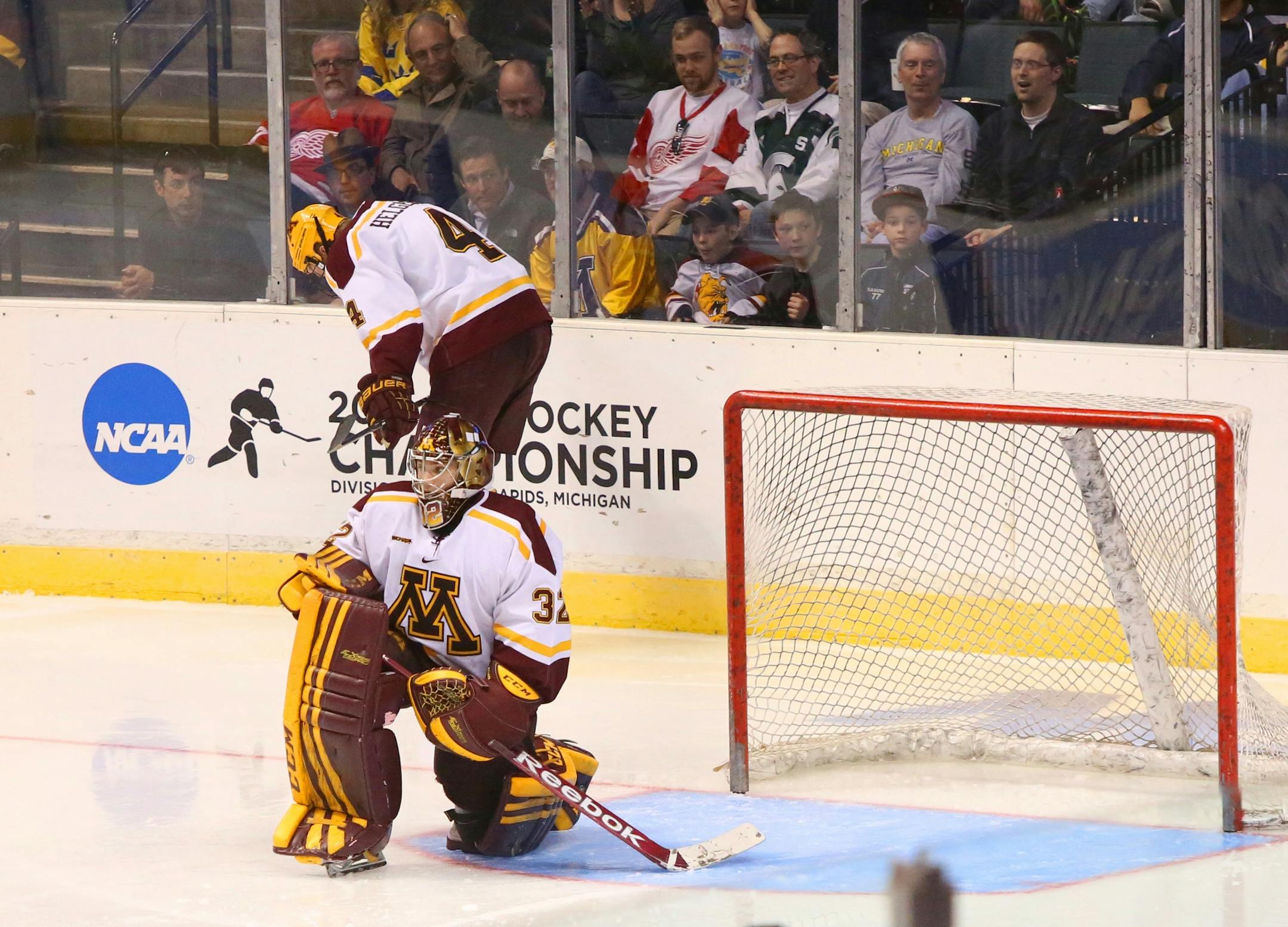 Minnesota goalie Adam Wilcox and Seth Helgeson are stunned after Yale beat the Gophers 9 seconds into overtime during the NCAA Western Regional