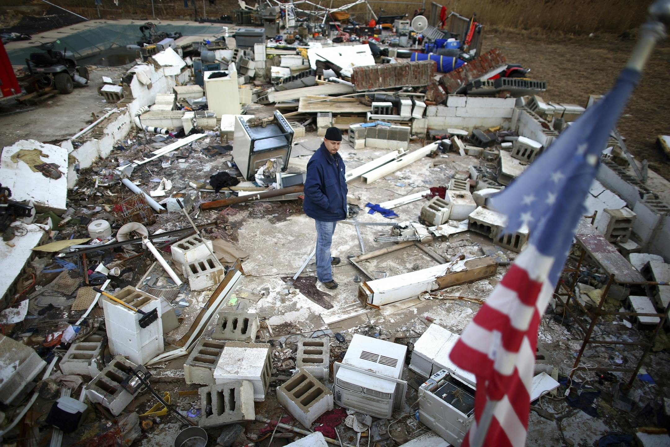 Pedro Correa stands in the remains of his home on Kissam Avenue in the Staten Island borough of New York, Nov. 30, 2012.