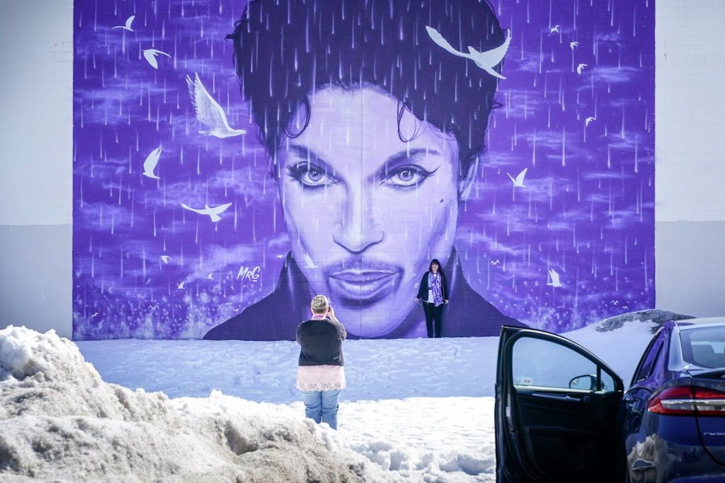 Prince fans Kim Barrington and Linda Lord flew to the Twin Cities this weekend for the second anniversary of Prince's death, taking turns photographing each other at the mural at the Chanhassen Cinema.