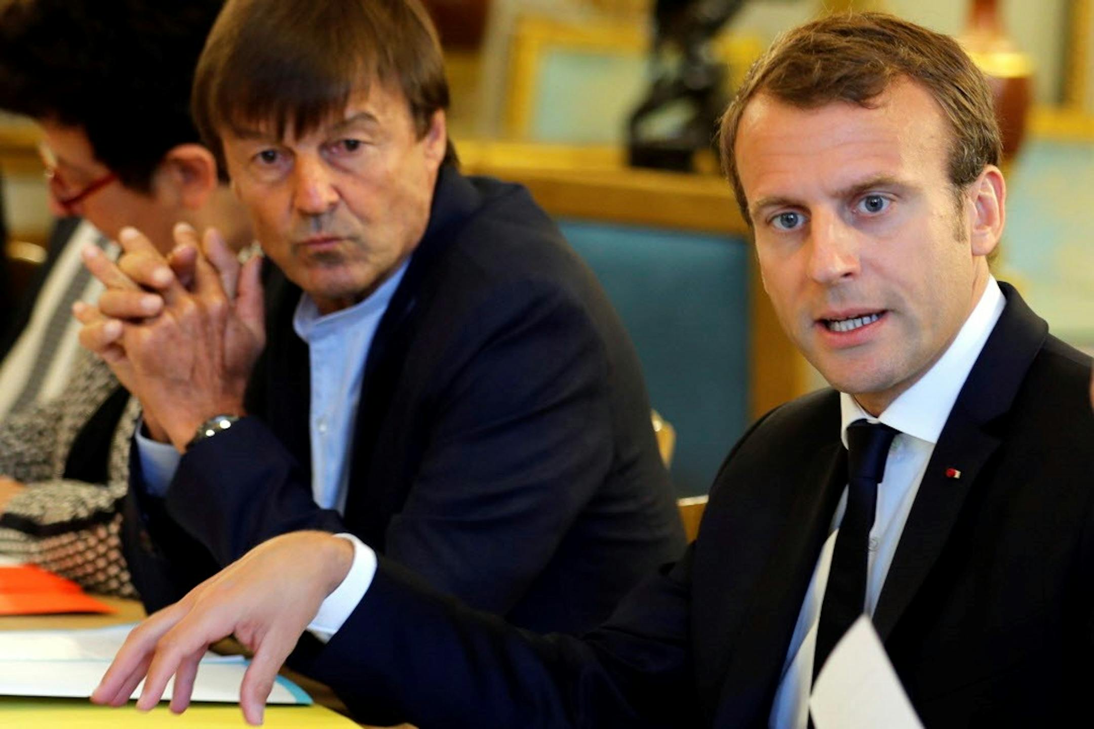 In this Sept.5 2017 photo, French President Emmanuel Macron, right, and Environment Minister Nicolas Hulot meet with NGOs to discuss climate and environment at the Elysee Palace in Paris. Macron is planning a climate summit next month to push his "Make our Planet Great Again" agenda, and to unveil the winners of his fellowship competition for U.S. climate scientists frustrated by the Trump administration's attitude toward global warming.