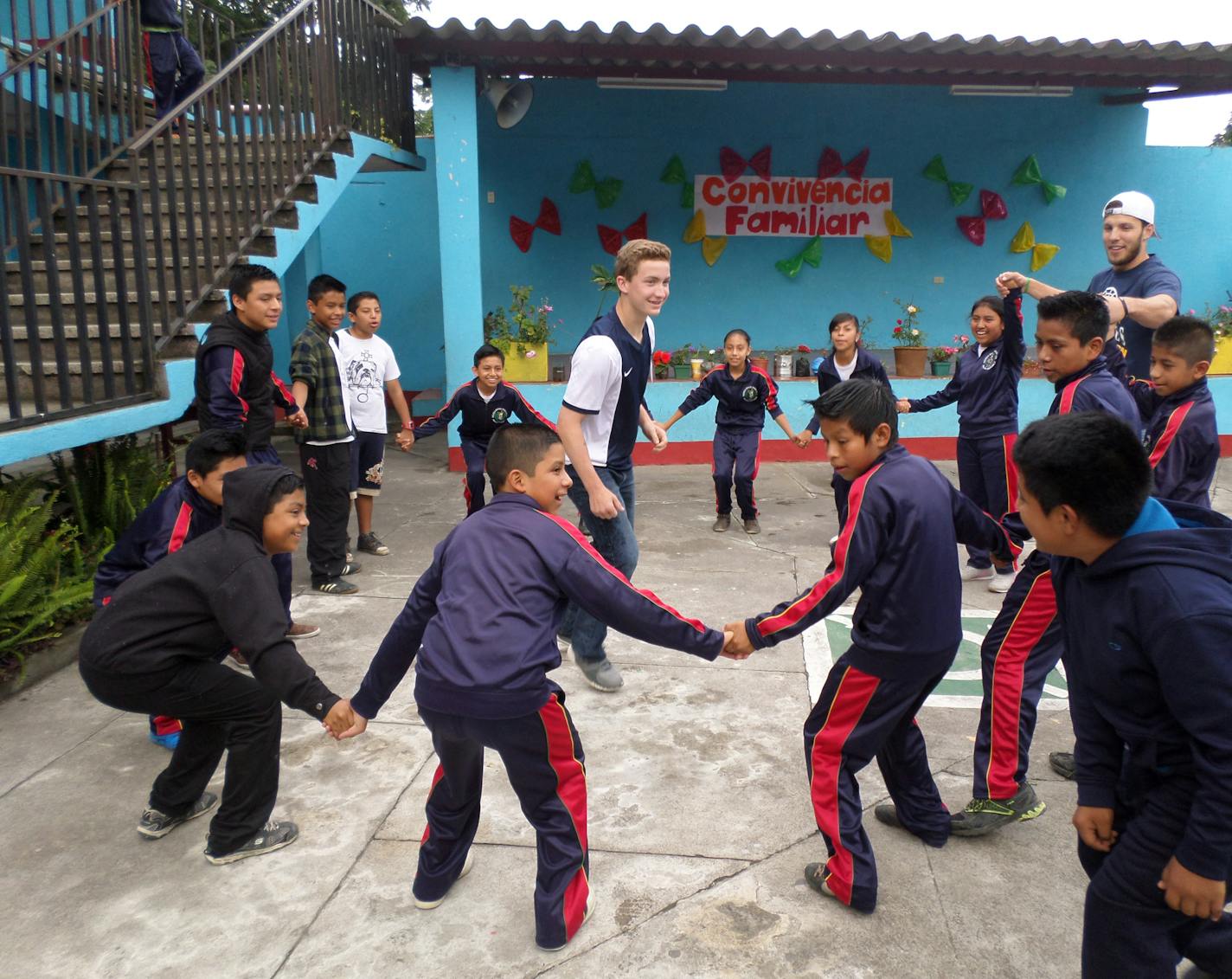 Totino-Grace High School student Jack Vettel and team leader Andrew Million play a game of Cat and Mouse with Guatemalan students from Common Hope&#xed;s school in Guardiania El Hato.