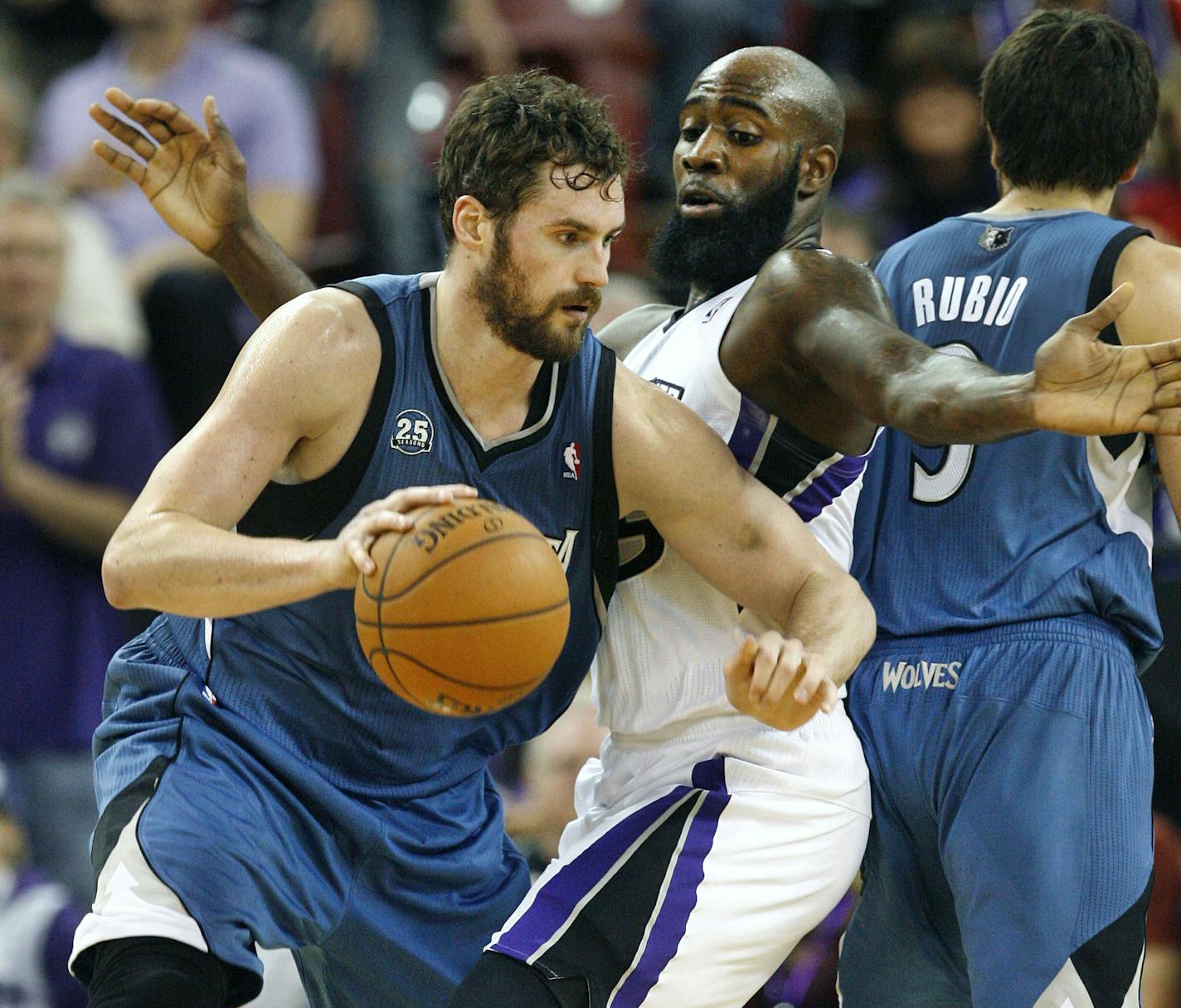 Minnesota Timberwolves forward Kevin Love, left, drives against Sacramento Kings defender Quincy Acy during the second half of an NBA basketball game in Sacramento, Calif., on Sunday, April 13, 2014.(AP Photo/Steve Yeater)