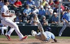 Tampa Bay Rays' Randy Arozarena slides into home plate to score on a passed ball as Minnesota Twins pitcher Trevor May, left, looks for a throw during
