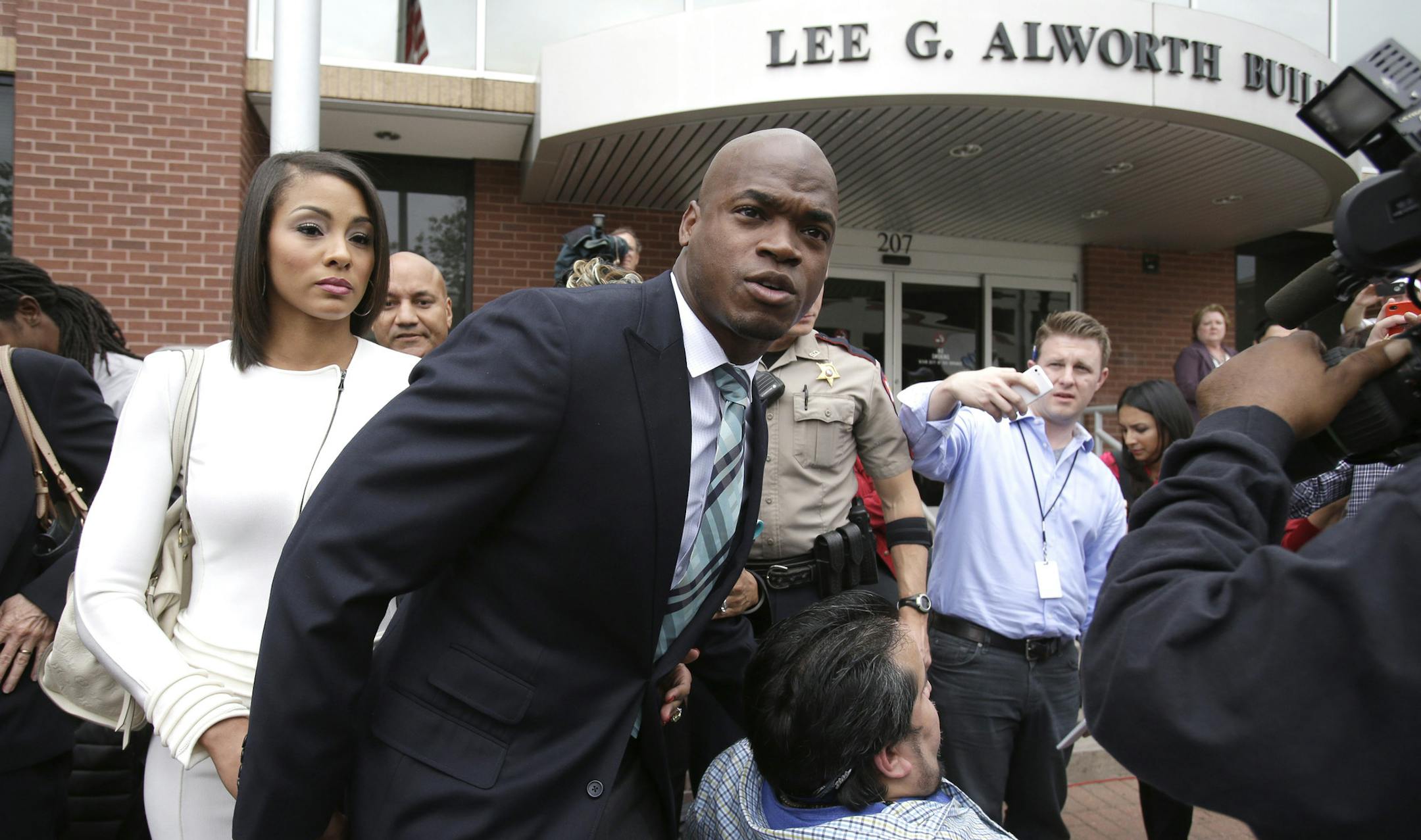 Minnesota Vikings running back Adrian Peterson leaves the courthouse with his wife Ashley Brown Peterson Tuesday, Nov. 4, 2014, in Conroe, Texas. Adrian Peterson avoided jail time in a plea agreement reached with prosecutors to resolve his child abuse case. (AP Photo/Pat Sullivan)