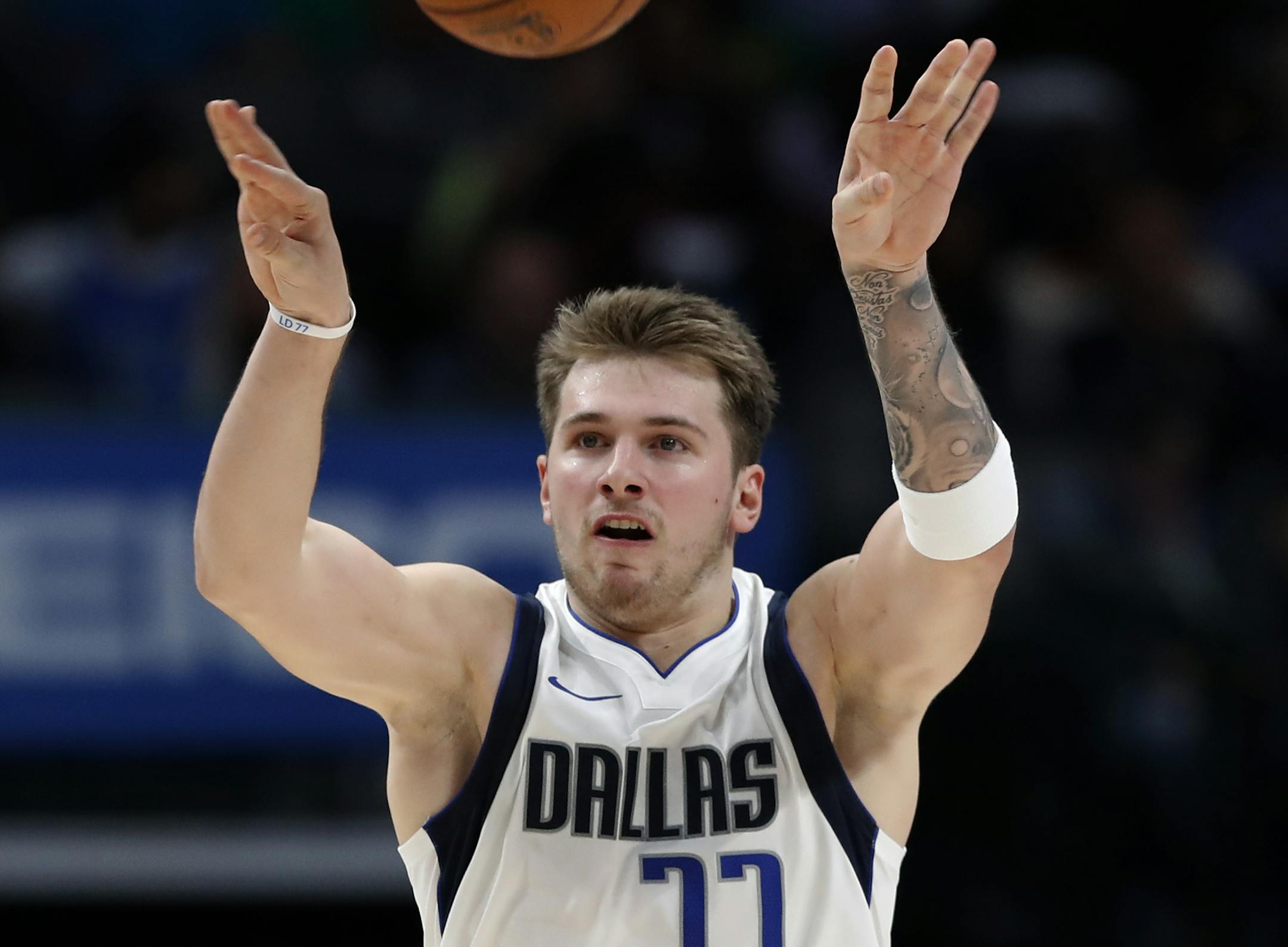 Dallas Mavericks guard Luka Doncic lobs the ball at the basket after play was called dead following a foul in the second half of an NBA basketball game against Toronto Raptors in Dallas, Saturday, Nov. 16, 2019. (AP Photo/Tony Gutierrez)