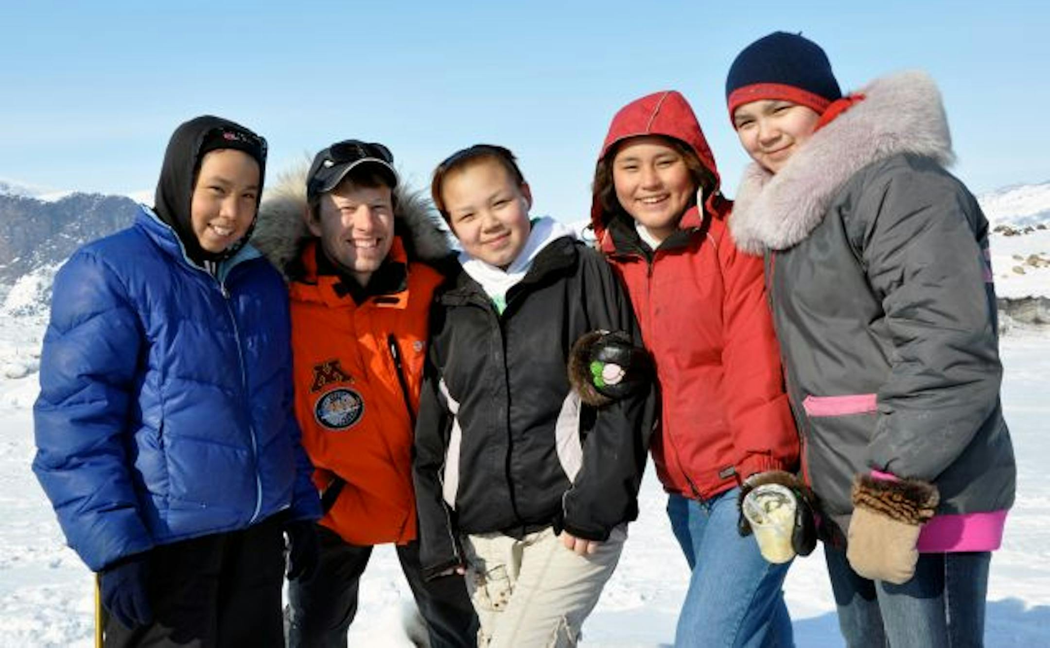 Chris Ripken, second from left, with kids from Pangnirtung. Ripken, a social studies teacher from Centennial High, spent time in local schools before embarking on a trek across the Cumberland Peninsula.