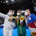 A very 2021 moment: Masks, selfies and some impromptu bonding. From left, gold medalist Suni Lee of St. Paul, Brazil’s Rebeca Andrade and Russian An