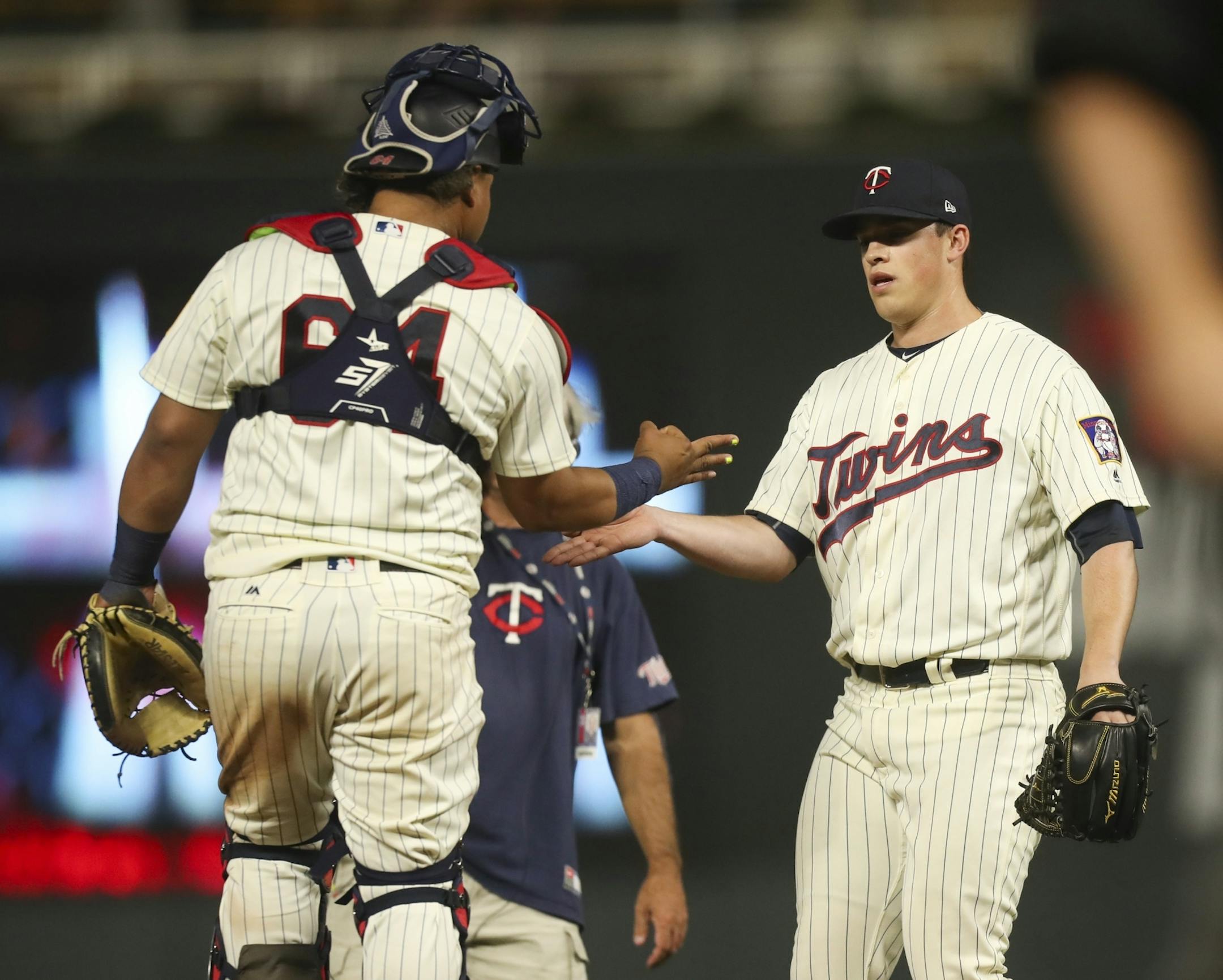 Twins catcher Willians Astudillo (64) and Twins closing pitcher Trevor Hildenberger congratulated each other after the final out of the game/