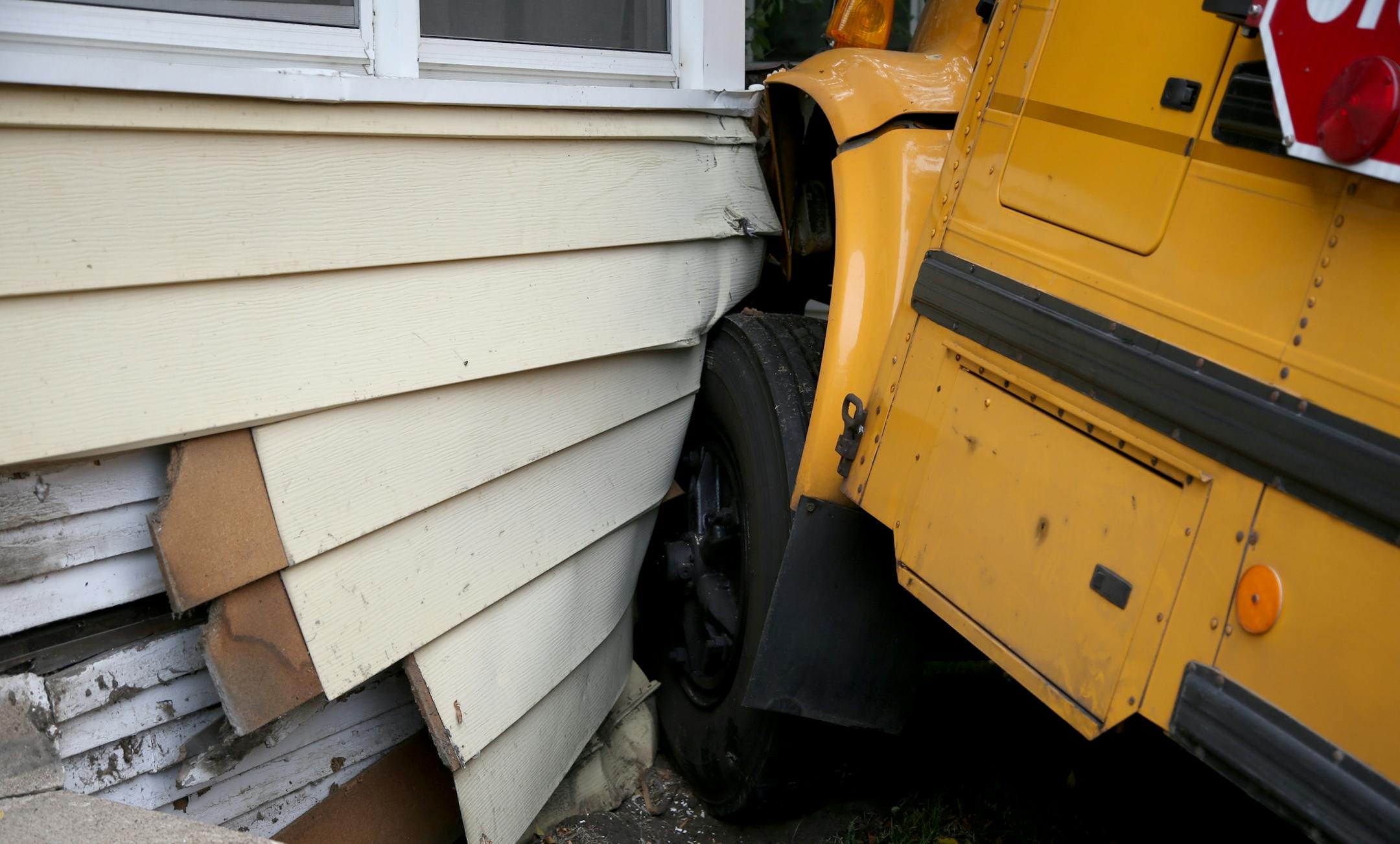 A schoo bus collided with another school bus and wound up crashing into the corner of the Rogers' home.