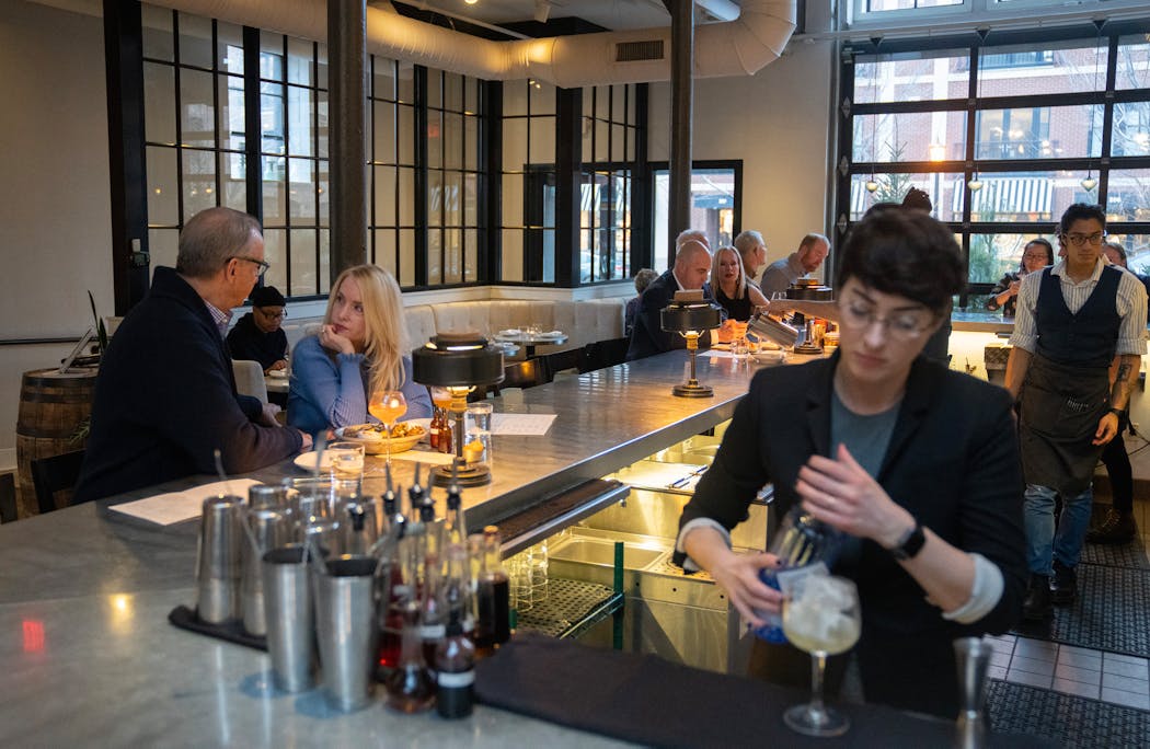 Mark Rosen and Karin Nelsen enjoyed happy hour while Jessi Pollak, beverage director, mixed a drink at Spoon and Stable in Minneapolis.