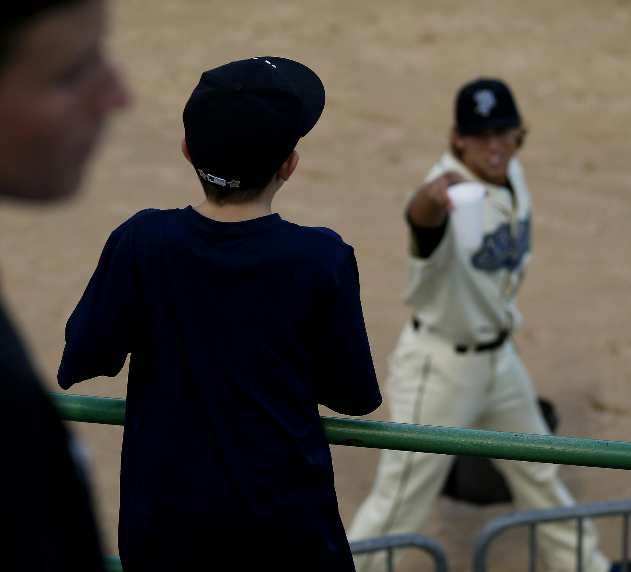 Luke Brouillette, 10 of Lino Lakes tried to get the attention of a Saints player before the start of Wednesday night's game. ] CARLOS GONZALEZ cgonzalez@startribune.com - August 27, 2014, St. Paul, Minn., Midway Stadium, St. Paul Saints baseball vs. Winnipeg