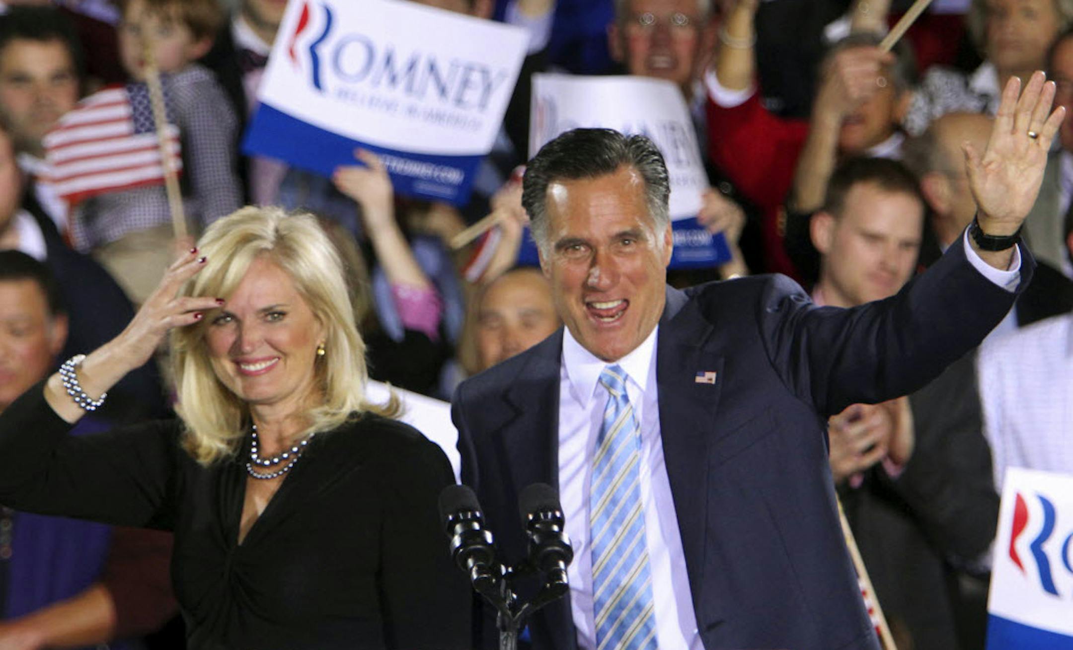 Republican presidential candidate Mitt Romney and his wife Ann wave to supporters Tuesday in Manchester, N.H.