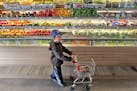Jose Chavez, 3, followed his mother Clara Osorio down the fruit and vegetable aisles at the Good Grocer grocery store, Monday, September 5, 2015 in Mi