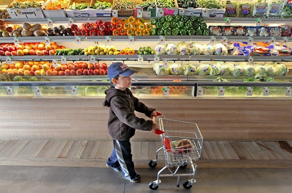 Jose Chavez, 3, followed his mother Clara Osorio down the fruit and vegetable aisles at the Good Grocer grocery store, Monday, September 5, 2015 in Mi