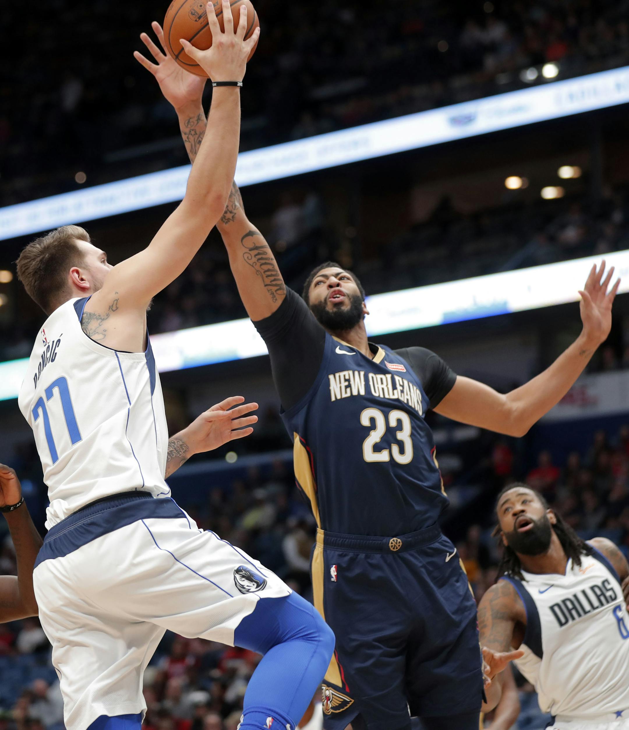 Dallas Mavericks forward Luka Doncic (77) goes to the basket against New Orleans Pelicans forward Anthony Davis (23) during the first half of an NBA basketball game in New Orleans, Friday, Dec. 28, 2018. (AP Photo/Gerald Herbert)