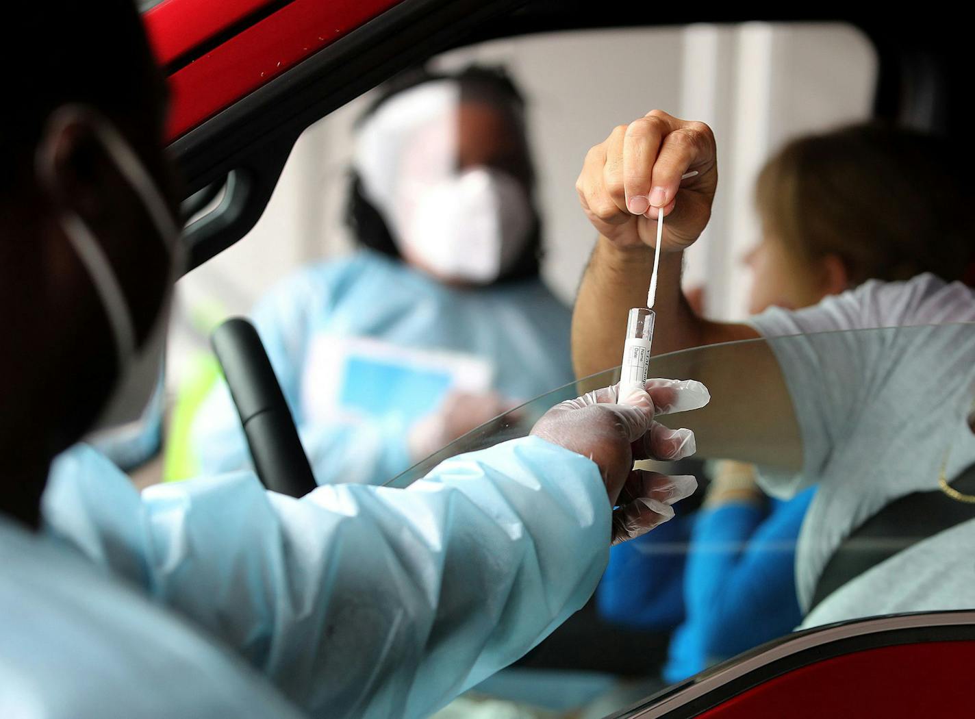 Health care workers collect samples at a testing site at the Miami-Dade County Auditorium in Miami Florida on July 23, 2020. (Mike Stocker/South Florida Sun Sentinel/TNS) ORG XMIT: 1756132