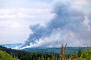Smoke billows from the Donnie Creek wildfire burning north of Fort St. John, British Columbia, Canada, Sunday, July 2, 2023. 